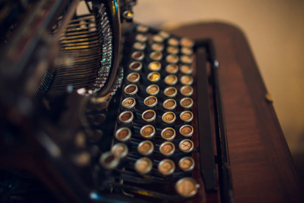 istock Old typewriter on wood on a blue background. 1143350007
