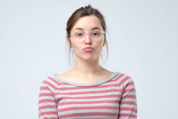 istock young woman pouting lips, making duck face 1143350172