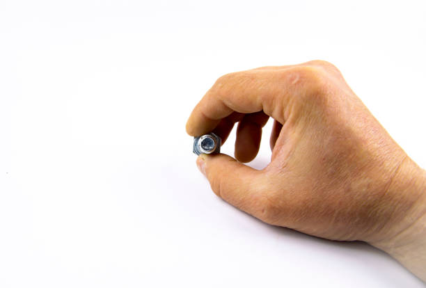 istock Metal bolt in a man's hand on a white background 1143351950