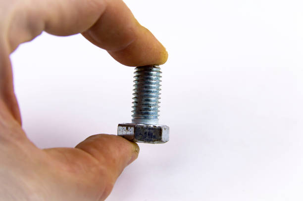 istock Metal bolt in a man's hand on a white background 1143352007