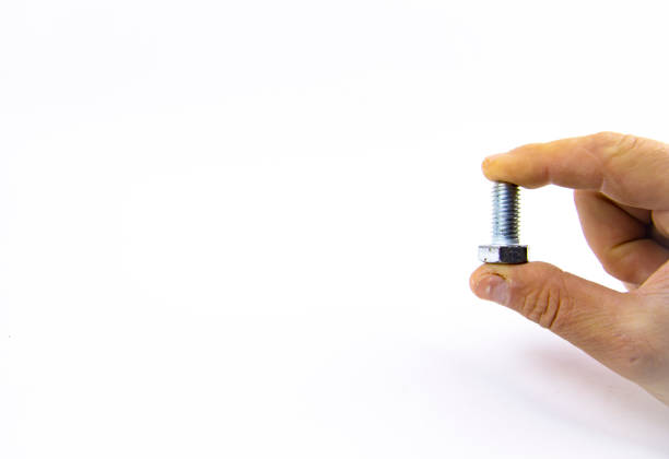 Metal bolt in a man's hand on a white background, place for text
