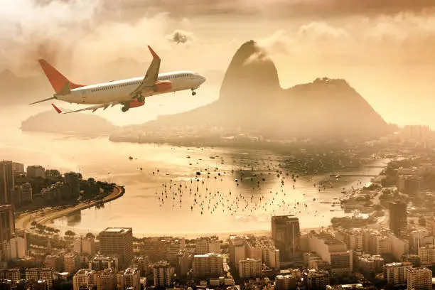 Airplane flying over Rio de Janeiro Guanabara Bay with Sugarloaf Mountain