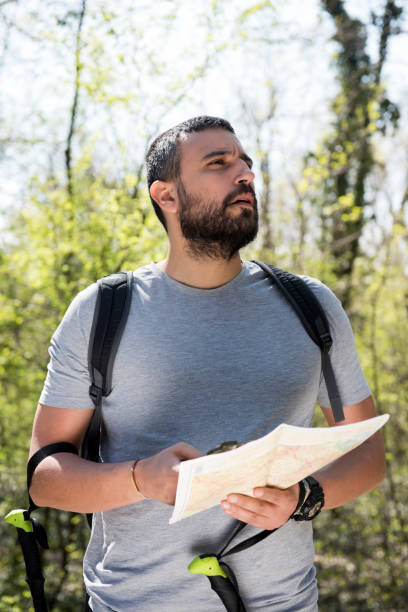 istock Male hiker using a map to locate the destination 1143353565
