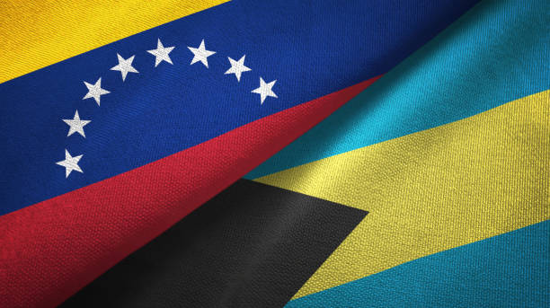istock Venezuela and Bahamas two flags textile cloth, fabric texture 1143353945