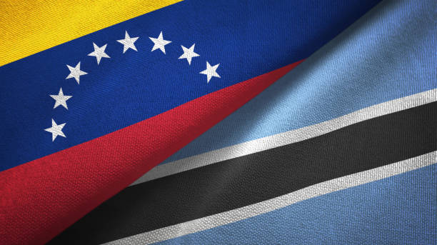 istock Venezuela and Botswana two flags textile cloth, fabric texture 1143353947