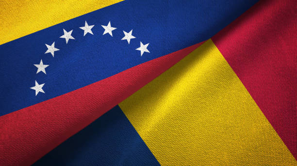 istock Venezuela and Chad two flags textile cloth, fabric texture 1143354073