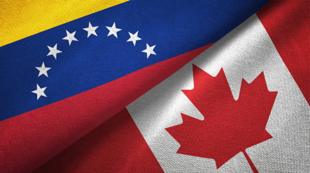 istock Venezuela and Canada two flags textile cloth, fabric texture 1143354123