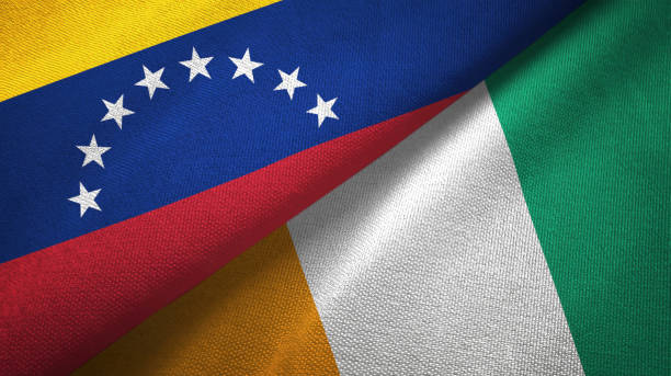 istock Venezuela and Cote d'Ivoire Ivory coast two flags textile fabric texture 1143354199