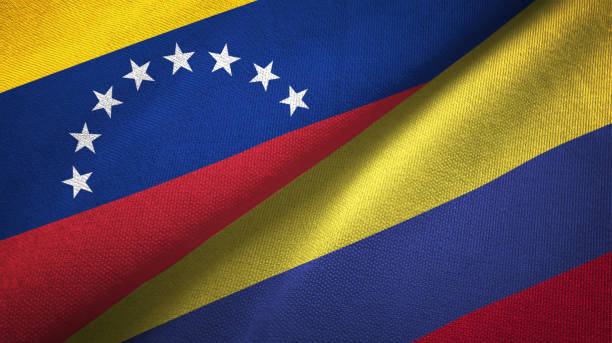 istock Venezuela and Colombia two flags textile cloth, fabric texture 1143354248