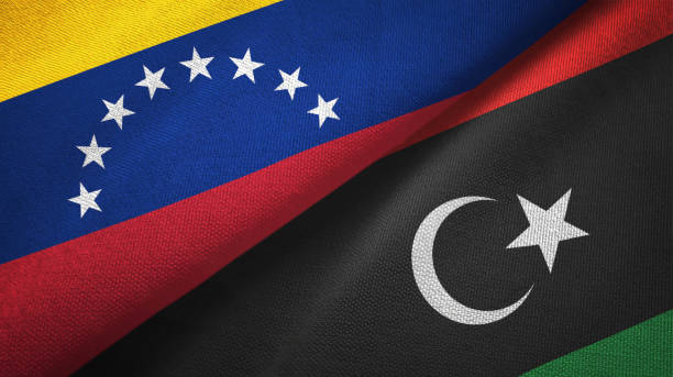 istock Venezuela and Libya two flags textile cloth, fabric texture 1143354279