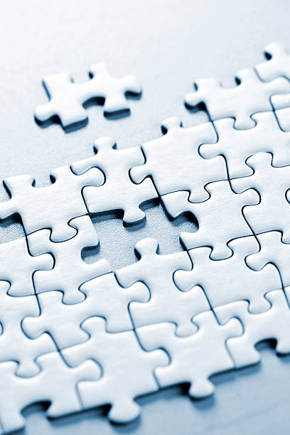 istock White jigsaw puzzle pieces with one not fitting, on white 114335518