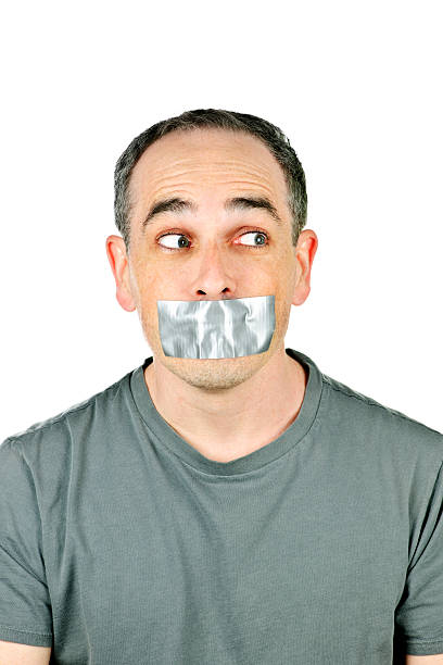 istock Man with duct tape on mouth 114335542