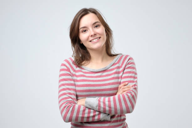 istock Smiling young caucasian woman with her arms folded 1143355616