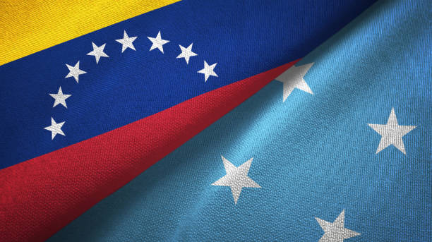 istock Venezuela and Micronesia two flags textile cloth, fabric texture 1143355750