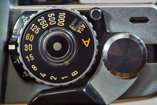 Photo of an old and vintage single lens reflex or SLR film camera at an outdoor park.