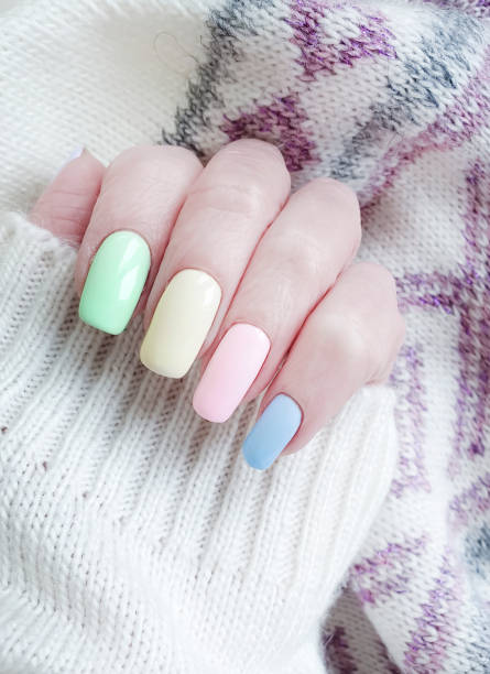 istock female hand, beautiful manicure, sweater 1143359262