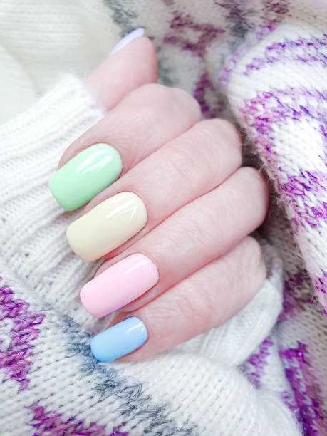 istock female hand, beautiful manicure, sweater 1143360854