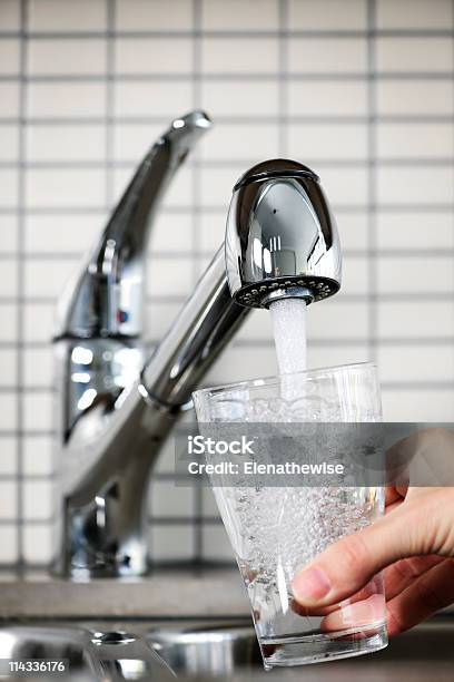 Glass Being Filled Under A Kitchen Faucet With Tap Water Stock Photo - Download Image Now