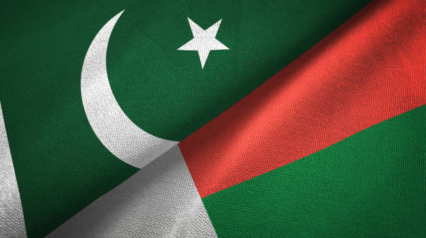 istock Pakistan and Madagascar two flags textile cloth, fabric texture 1143363609
