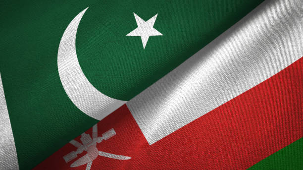 istock Pakistan and Oman two flags textile cloth, fabric texture 1143364437