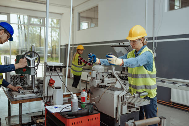 istock Female employees working on CNC machines. 1143365419