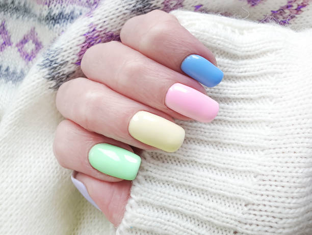istock female hand, beautiful manicure, sweater 1143365480
