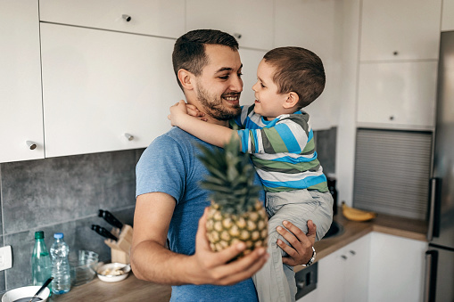 Father and son in kitchen, preparing healthy breakfast