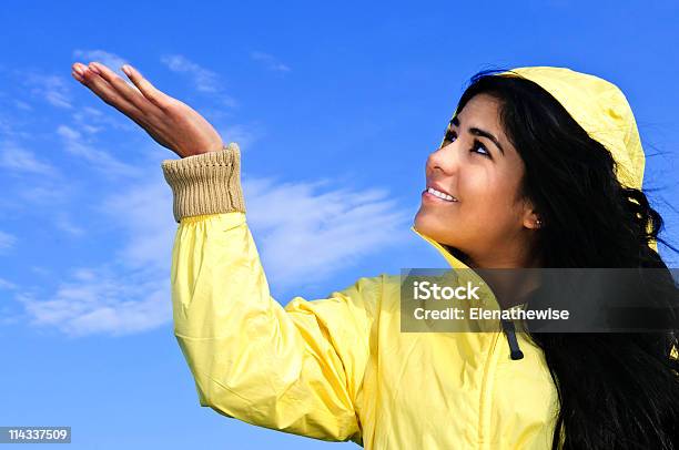 Beautiful Young Woman In Raincoat Checking For Rain Stock Photo - Download Image Now