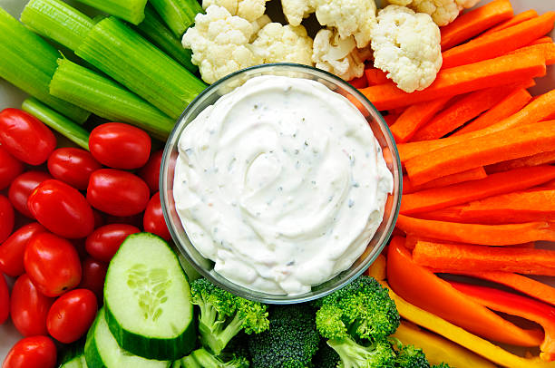 istock Top view of fresh cut vegetables surrounding cup of dip 114337521