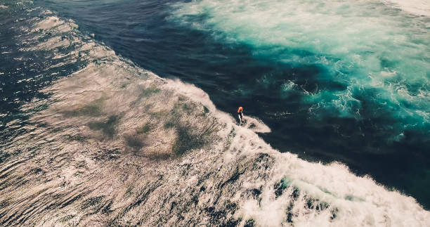 istock Aerial view surfers and wave in tropical ocean. Top view 1143375931