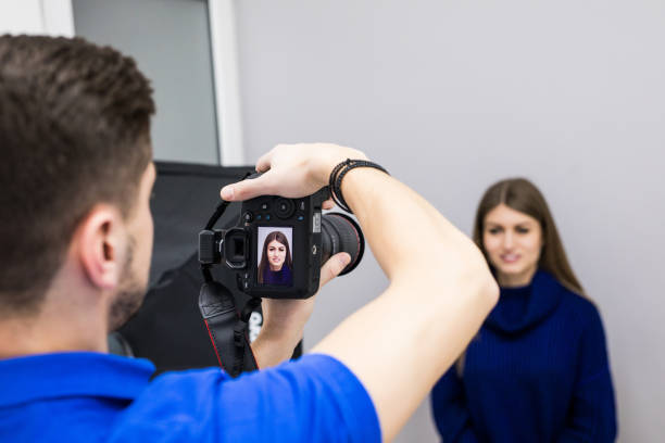 istock Dentist man with camera and patient shooting patient before working on teeth 1143375940