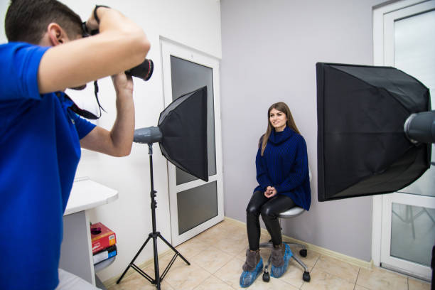 istock Dentist man with camera and patient shooting patient before working on teeth 1143375950