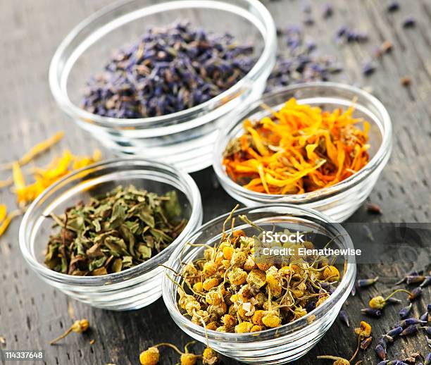 Four Different Kinds Of Dried Medical Herbs In Glass Bowls Stock Photo - Download Image Now
