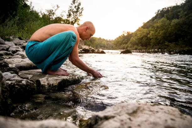 istock Young Adult Man Refreshing By a River 1143377433