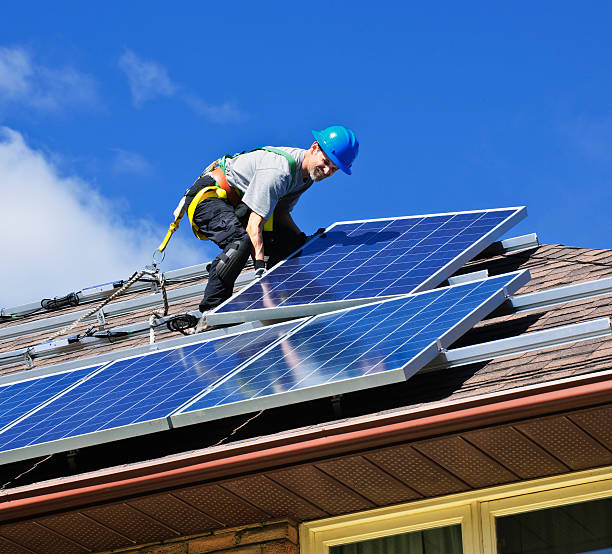 Solar panel installation Man installing alternative energy photovoltaic solar panels on roof Solar Energy stock pictures, royalty-free photos & images