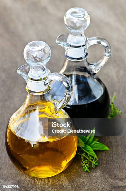 Bottles Of Oil And Vinegar On Wooden Table Stock Photo - Download Image Now - Bottle, Vinegar, Balsamic Vinegar