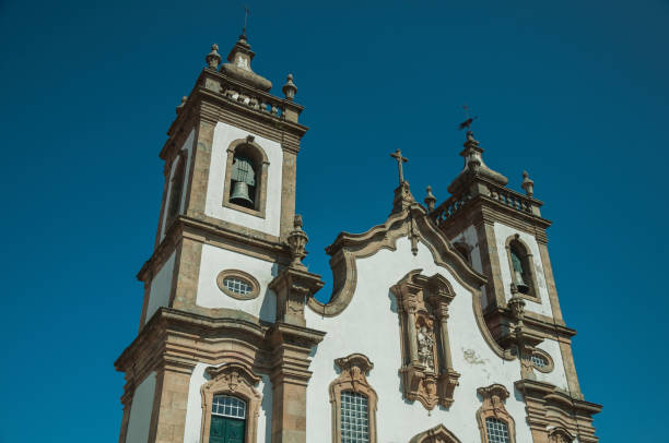 baroque bell towers from church with whitewashed wall - castelo de vide imagens e fotografias de stock
