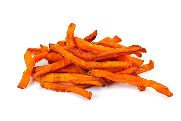 a handful of sweet potato fries on a white background - zoete aardappel fotos stockfoto's en -beelden
