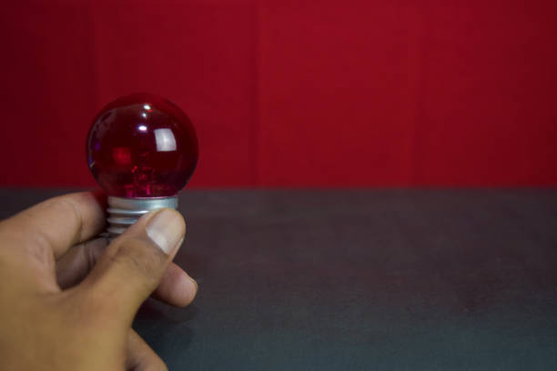 istock Close up lamp in red background and black table 1143385851