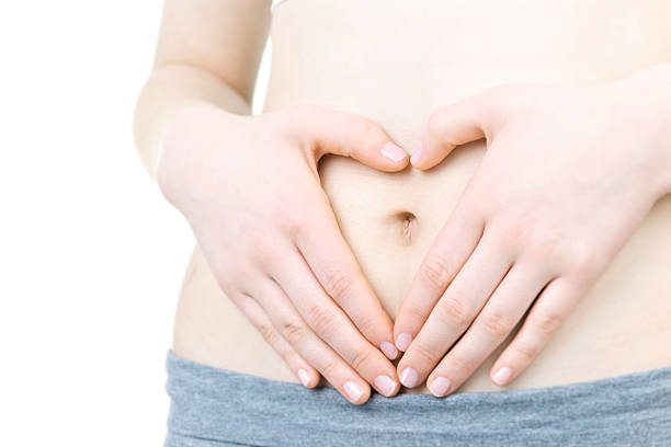 istock A mommy making a shape of a heart on her tummy  114338875