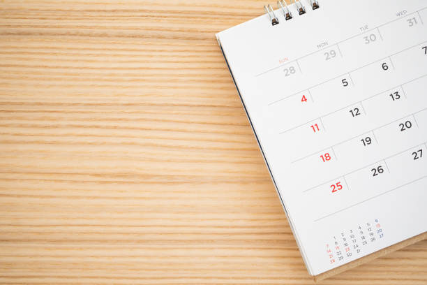 istock calendar page on wood table background 1143389977