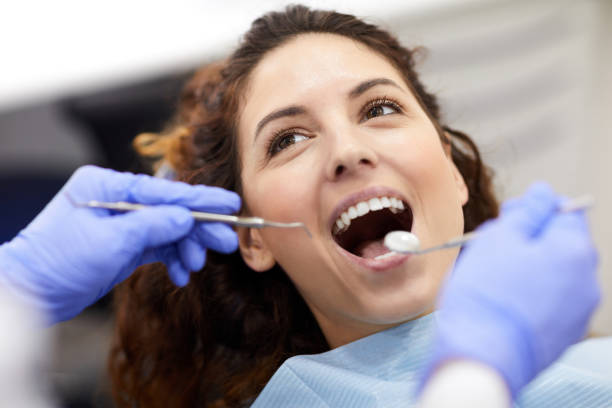 istock Young Woman at Dental Exam 1143393783