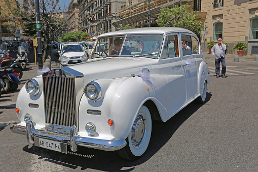 Naples, Italy - June 22, 2014: White Rolls Royce Luxury Wedding Car With Driver in Napoli, Italy.