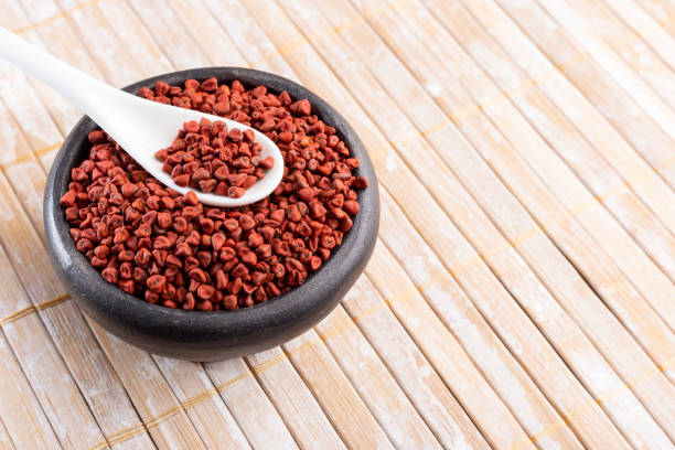 istock Annatto seeds on rustic wood 1143399085