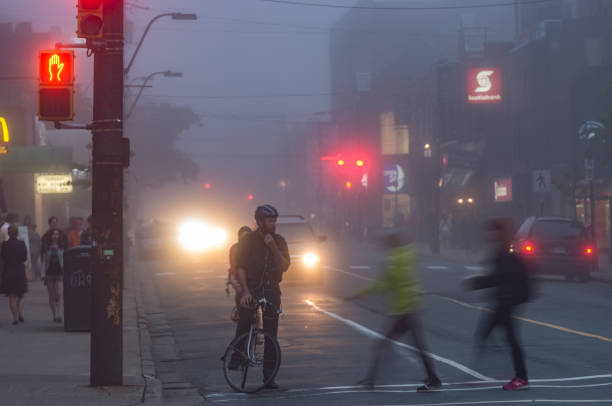 Halifax, Canada - July 28, 2014 - Pedestrians, bicyclists and traffic on busy Spring Garden Road in dusk light.