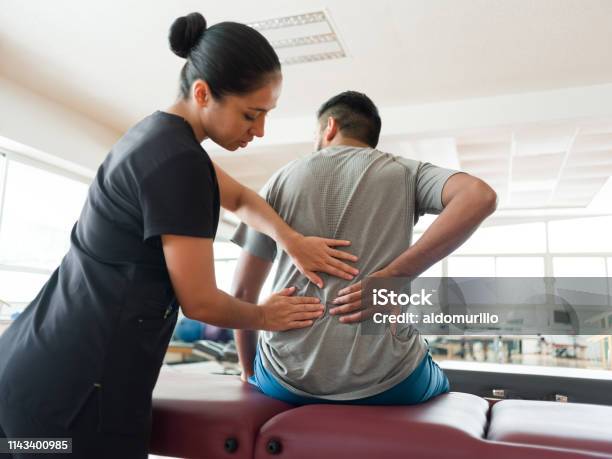 Female Massage Therapist Massaging Patients Back Stock Photo - Download Image Now - Physical Therapy, Backache, Rear View