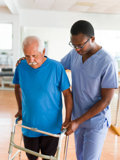 istock Male nurse helping man walk with support 1143401064