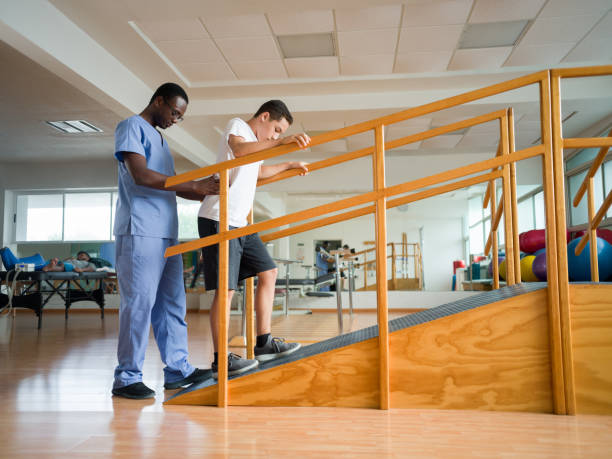 istock Teenage boy stepping up physical therapy ramp 1143401094