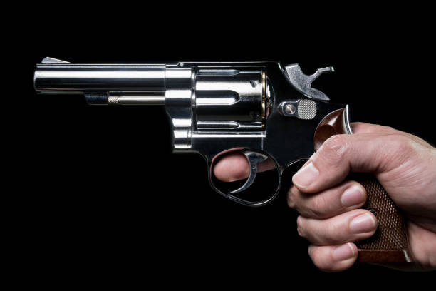 istock Stainless Gun or Shooter in Human Hand Side View 1143409079