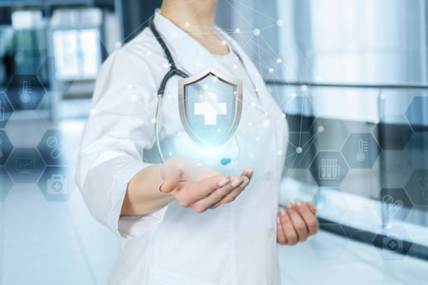 istock A doctor is showing a shield with medical symbol inside. 1143409387